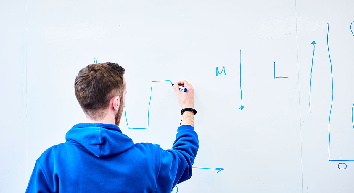 A student working on a whiteboard